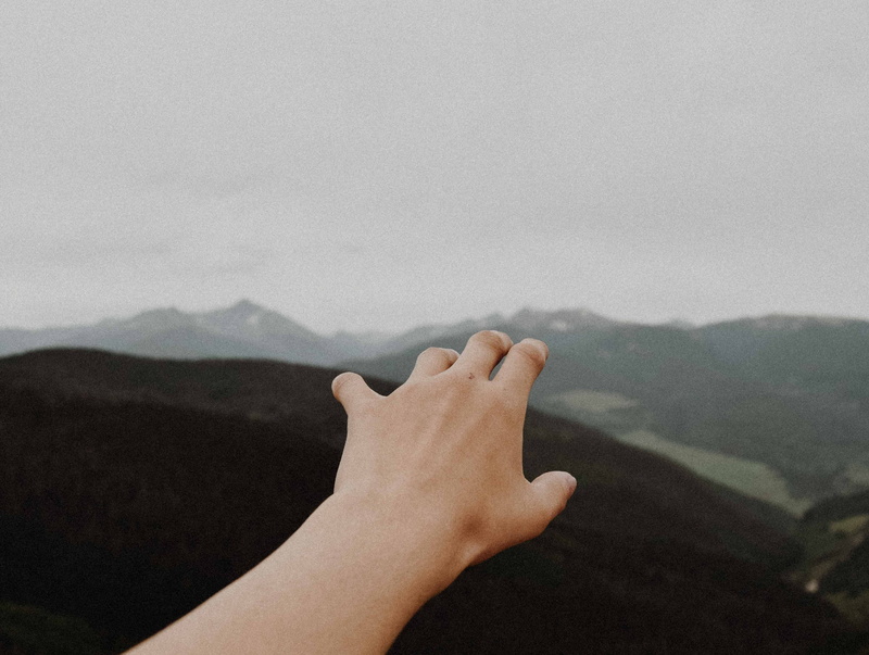 mountain, mountains, person, left, hand, day, personal perspective, lifestyles, nearby, one person, outdoors, human limb, body part, human finger, arm