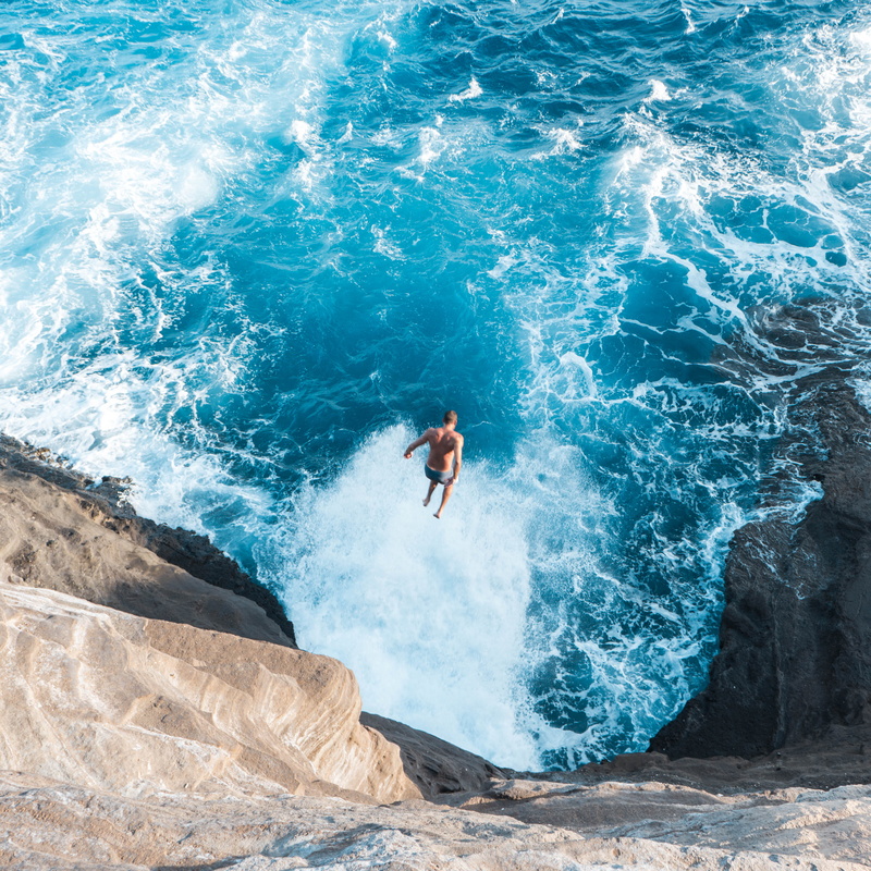 photo, cliff, real people, men, sport, wave, one person, outdoors, sendit, beach, high angle view, male, land, man, sea, rocks, aerial, rock - object, blue