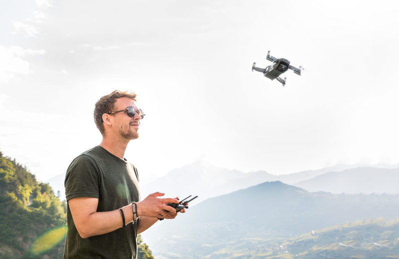 drone pilot, casual clothing, flying object, mid adult, technology, day, man, 5K, copter, glasses, air vehicle, mountains, real people, flying, sunglasses