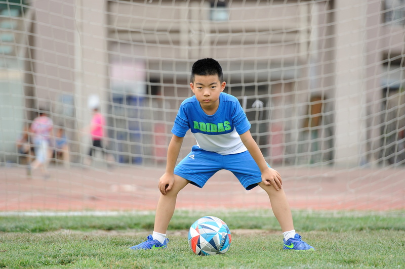 ball, healthy lifestyle, athlete, soccer, exercising, boy, sport, sports training, football, full length, young adult, motion, playing, sports, greenery