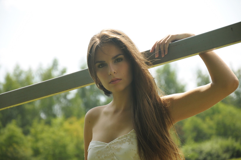 focus on foreground, hairstyle, hand, outdoors, s, fashion, nature, portrait, girl, tube, beautiful woman, headshot, women, standing, beauty, looking at camera