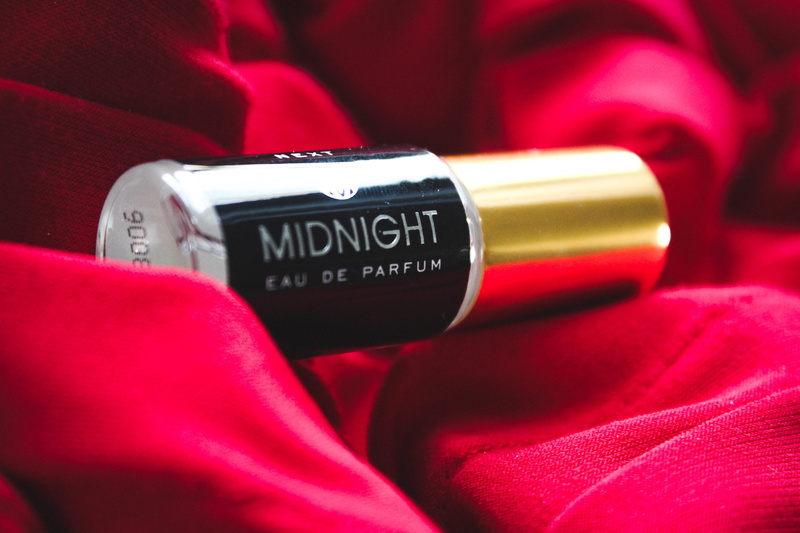 red, maroon, real people, logo, trademark, metal, text, focus on foreground, lifestyles, cosmetics, close-up, indoors, lipstick, bottle, aluminium, deodorant