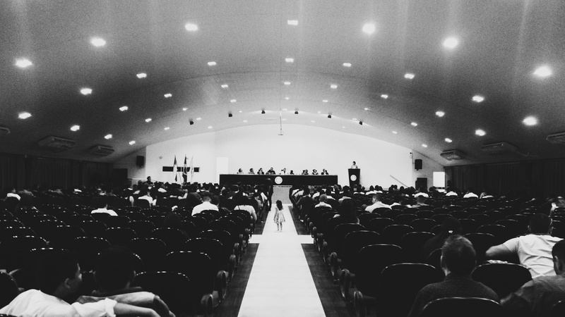 event, ceiling, human, lighting, real people, interior design, architecture, grey, men, large group of people, sitting, illuminated, grayscale, in a row