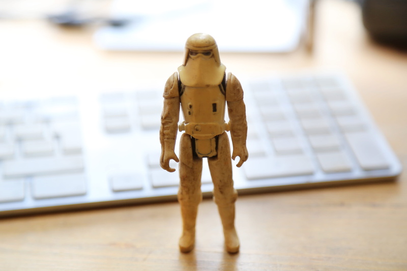 table, snowtrooper, indoors, small, male likeness, technology, focus on foreground, figurine, london, still life, apple, keyboard, episode v, kenner, creativity