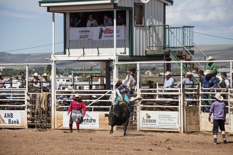 man, mode of transportation, nature, text, rodeo, sky, occupation, transportation, adult, group of people, bull rider, large group of people, cowboys, spurs