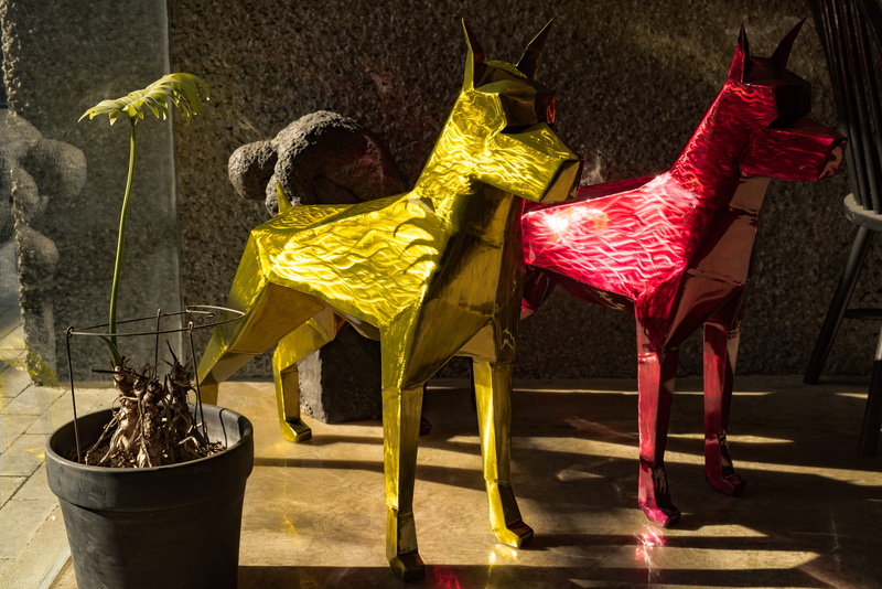 animal, origami, bird, architecture, creativity, art and craft, statue, plant, glass, day, asphalt, seat, clothing, art, figurine, yellow, decoration, paper