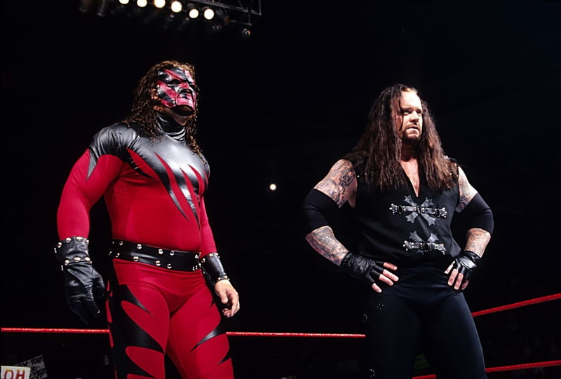 front view, WWE, The Undertaker, young adult, real people, two people, clothing, sport, standing, hairstyle, three quarter length, people, night, long hair