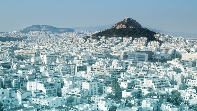 building, built structure, city, office building exterior, outdoors, high angle view, cityscape, mountain, nature, skyscraper, aerial view, capital, hills