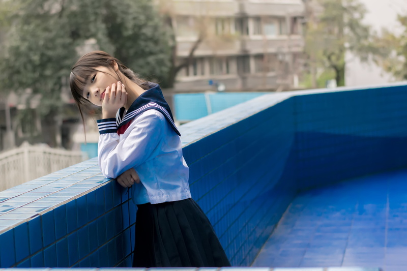 sunlight, building exterior, white, nature, standing, 5K, waist up, focus on foreground, JK, architecture, school, teenager, one person, real people, side view