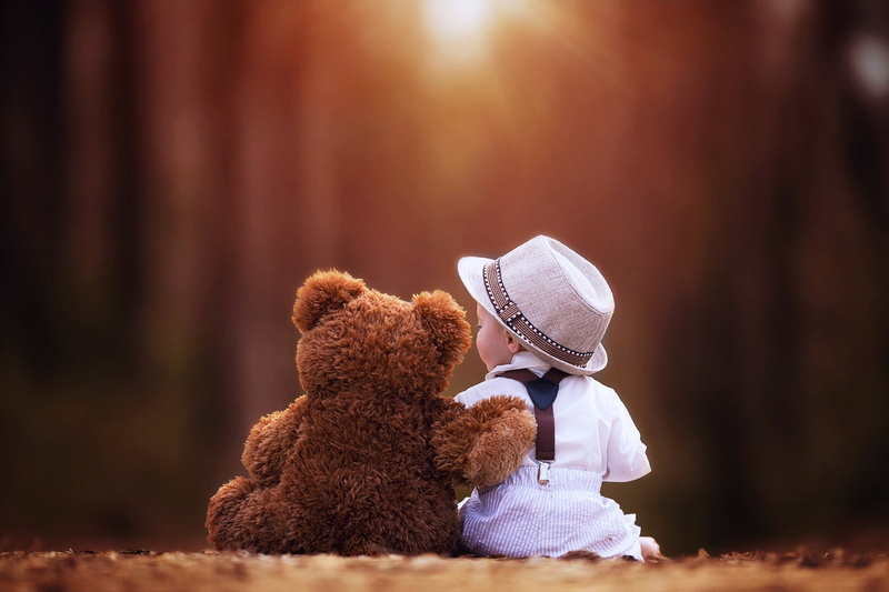 stuffed toy, childhood, outdoors, lifestyles, playful, Teddy Bear, Child, bear, women, sunlight, playing, hairstyle, innocence, small, focus on foreground