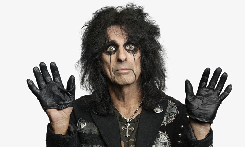 indoors, headshot, human face, looking at camera, simple background, hand, standing, singer, shock rock, portrait, adult, rock stars, music, hairstyle