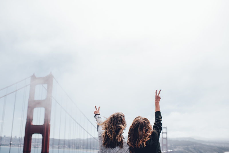 gesturing, outdoors, architecture, portrait, leisure activity, headshot, adult, mist, peace sign, hand raised, real people, built structure, long hair