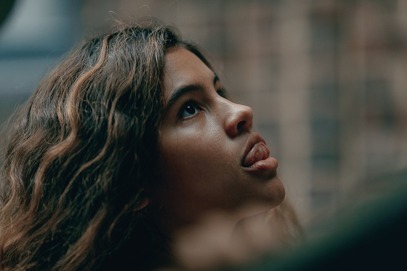 hair, leisure activity, tongue out, headshot, one person, depression - sadness, young adult, outdoors, focus on foreground, looking, human face, young women