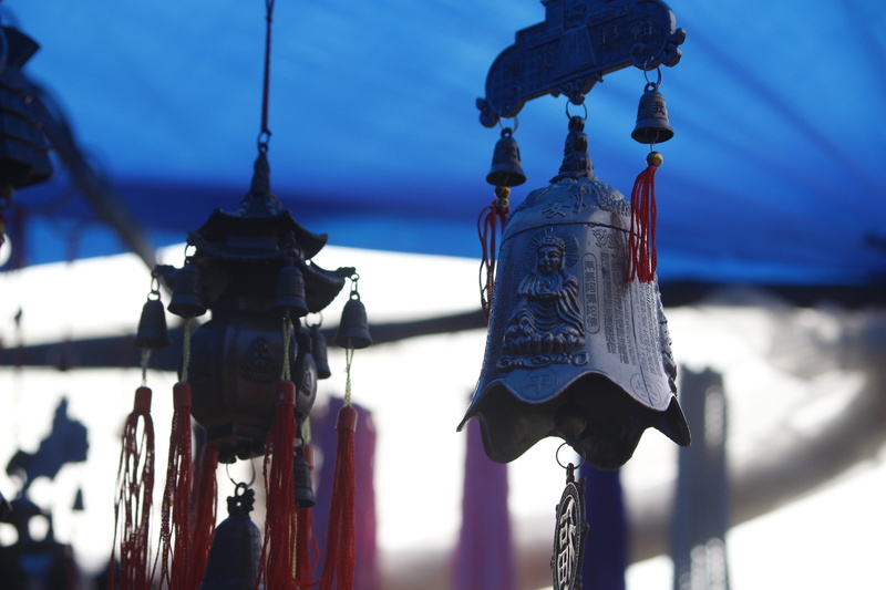 building, place of worship, decorative, chime, metal, low angle view, architecture, sky, day, lighting equipment, focus on foreground, religion, wind chimes
