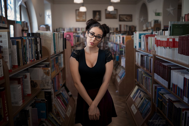 brown, eyeglasses, young women, woman, hairstyle, books, bookshelf, black, shelves, standing, hairbun, beauty, book, sleeved, looking at camera, glasses