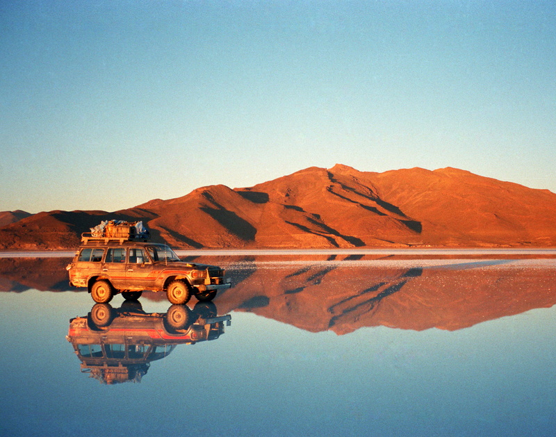 scenics - nature, nature, clear sky, mode of transportation, beauty in nature, orange, bolivia, reflection, copy space, desert, building, architecture