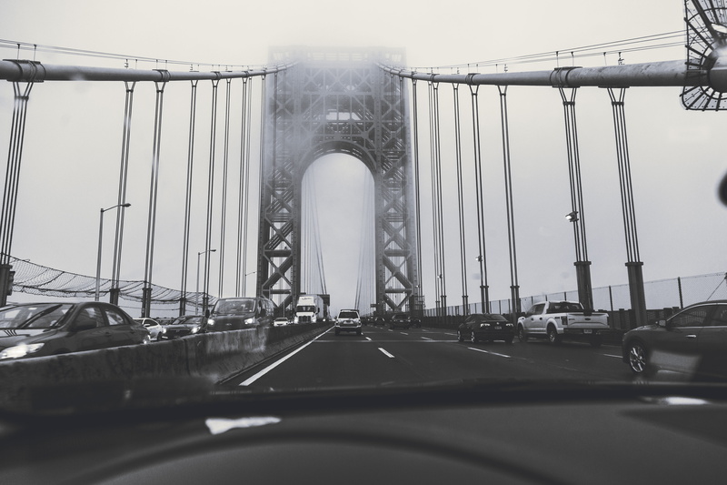 lights, daylight, travel destinations, transportation system, pavement, steel, motor vehicle, windshield, vehicles, built structure, suspension bridge