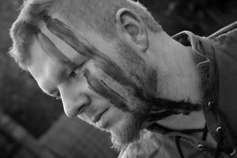 lifestyles, real people, one person, historical costume, portrait, adult, looking down, medieval, battle, weapon, blood, war paint, men, side view, contemplation