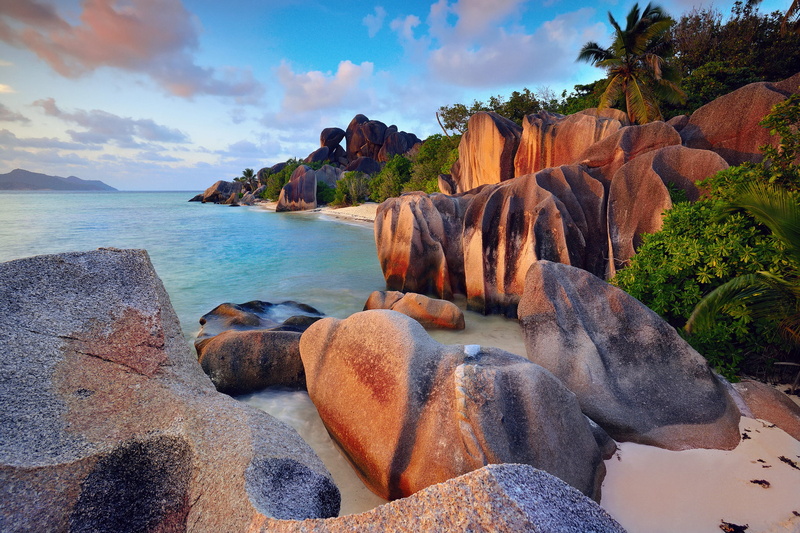 the sky, rock - object, tree, the bushes, clouds, trees, rocky coastline, solid, La Digue island, stones, body, beach, leafed, water, The Indian ocean