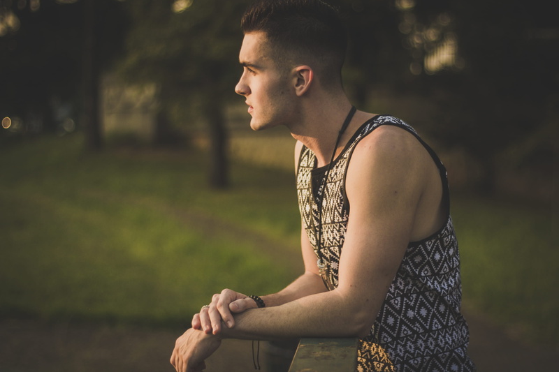 focus on foreground, looking away, tattoo, standing, black, side view, looking, close-up, day, 4K, good-looking, three quarter length, depth of field