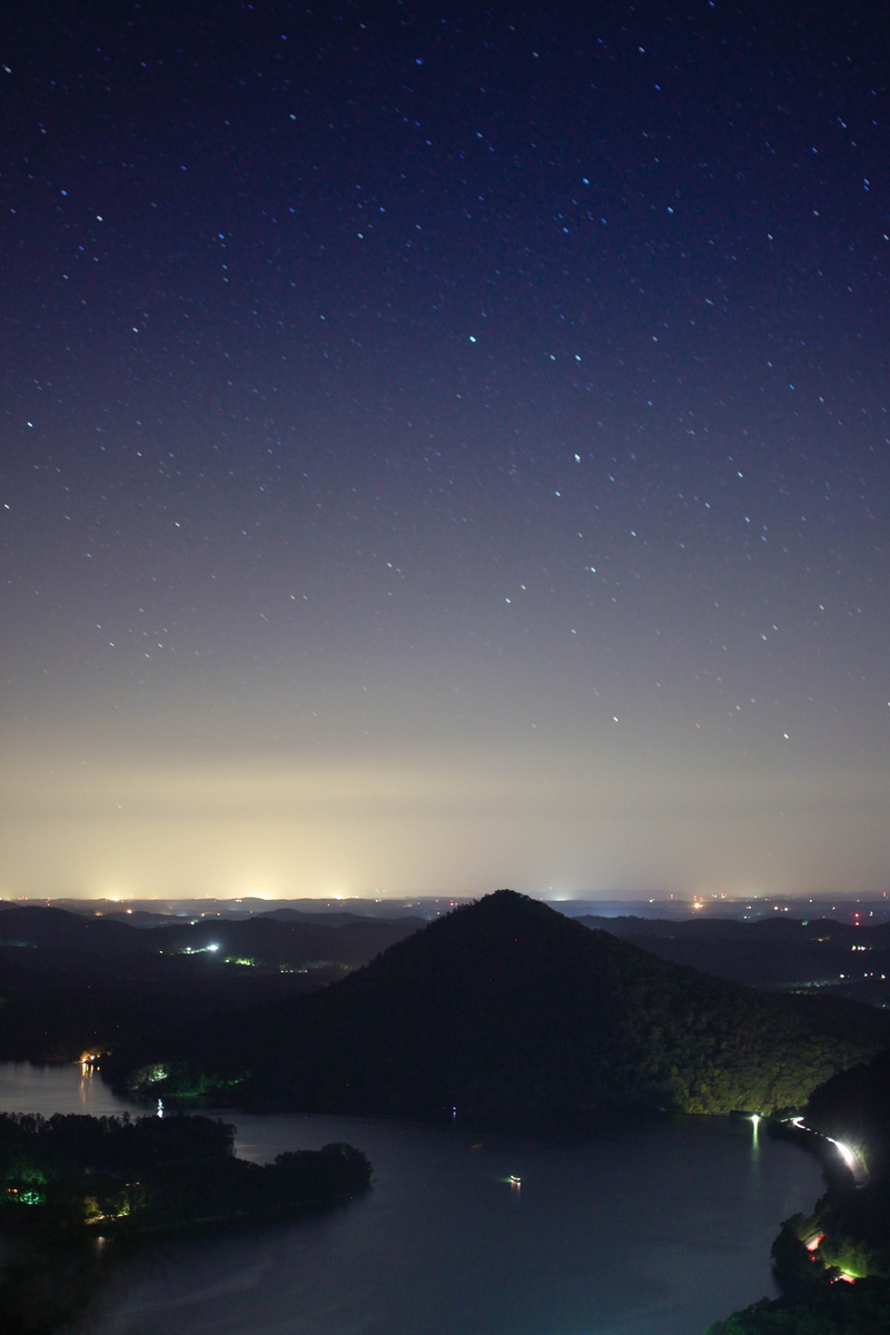 astronomy, beauty in nature, building exterior, illuminated, dark, urban, stargazing, star - space, tranquility, water, architecture, night, aerial, no people