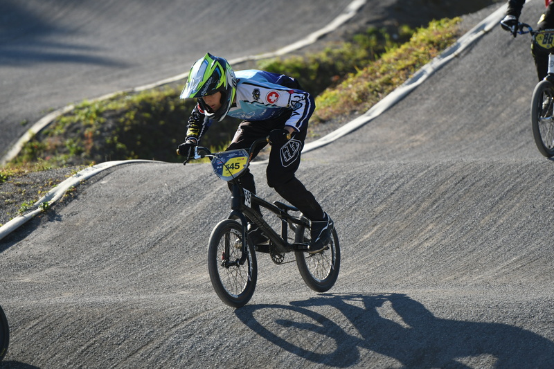 one person, road, motion, nature, action, shadow, transportation, day, competition, bike, activity, helmet, sunlight, sports clothing, headwear, bicycle
