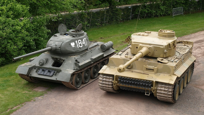 no people, tank, grass, field, green color, tree, security, mode of transportation, vehicle, army, weapon, growth, plant, tanks, transportation, high angle view