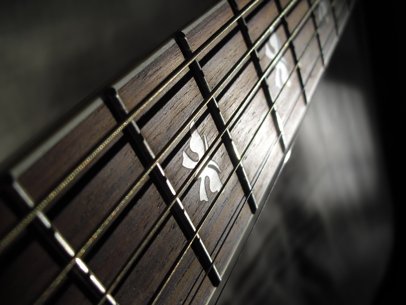 strings, Guitar, musical instrument, single object, focus on foreground, black color, music, still life, black background, Frets, indoors, musical instrument string