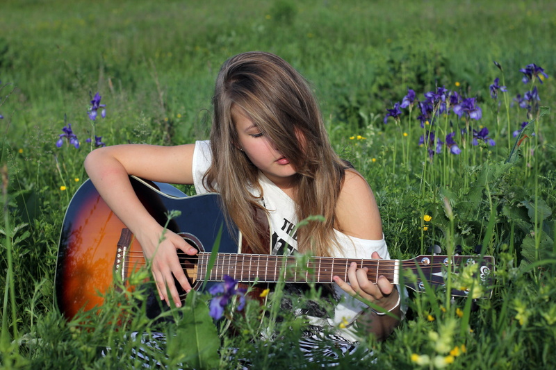 teenage Girls, sitting, enjoyment, lifestyles, hobbies, string instrument, GRIF, one Person, teenager, long hair, musician, springtime, hair, relaxation