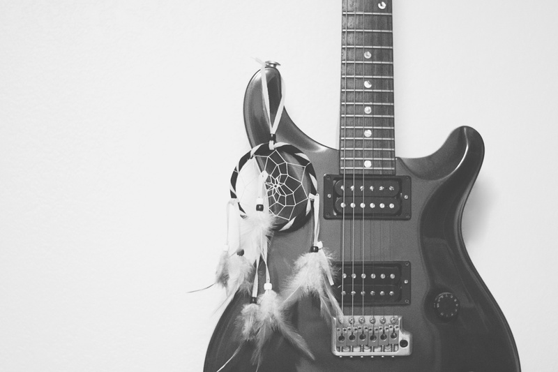 electric guitar, electric, string, hanging, metal, indoors, string instrument, sound, grayscale, representation, equipment, bowed stringed instrument, rock