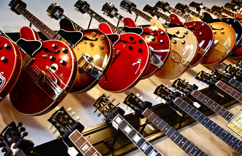 lot, 4K, large group of objects, neck, store, for sale, still life, wall, indoors, red, retail display, no people, string instrument, music, choice, arrangement