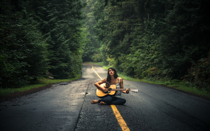 road, dreadnought, one person, acoustic, leisure activity, music, cross-legged, full length, outdoors, transportation, nature, casual clothing, forest