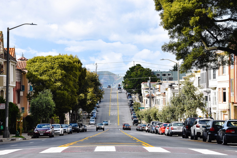 housing, hill, sky, town, diminishing perspective, land vehicle, direction, sign, outdoors, sidewalks, san francisco, car, nature, parked, roadside, transportation