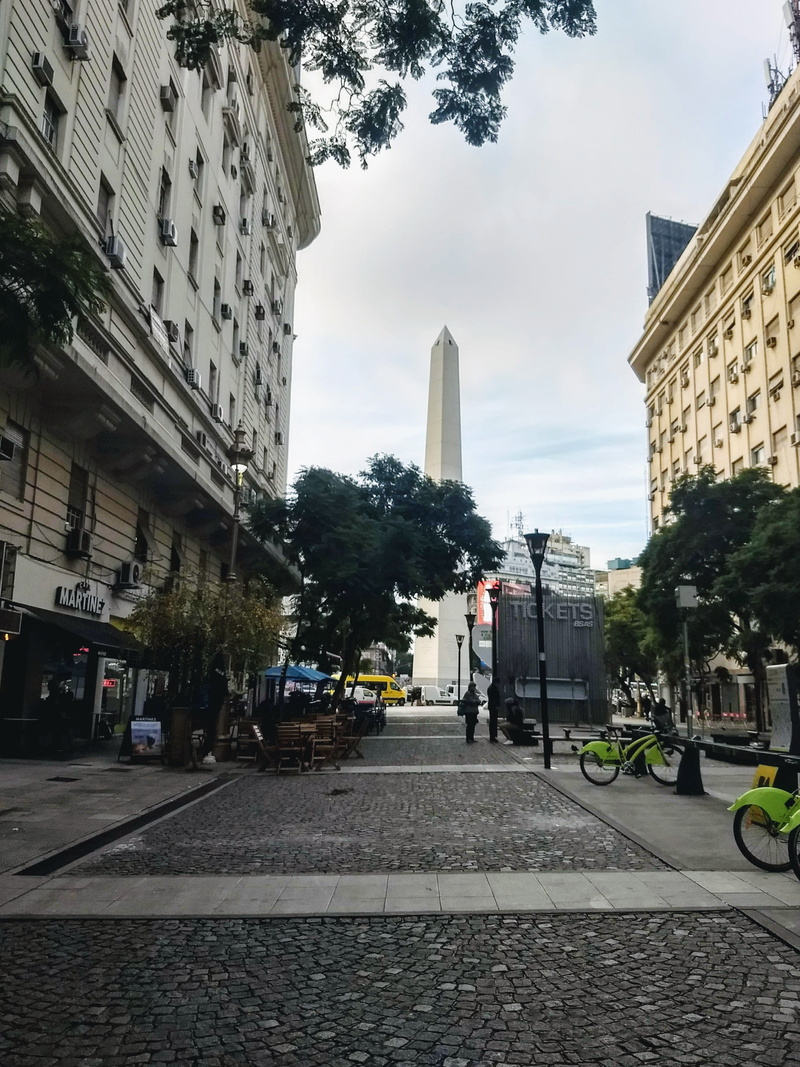city life, building exterior, obelisco, built structure, obelisk, road, city, the way forward, real people, architecture, transportation, office building exterior