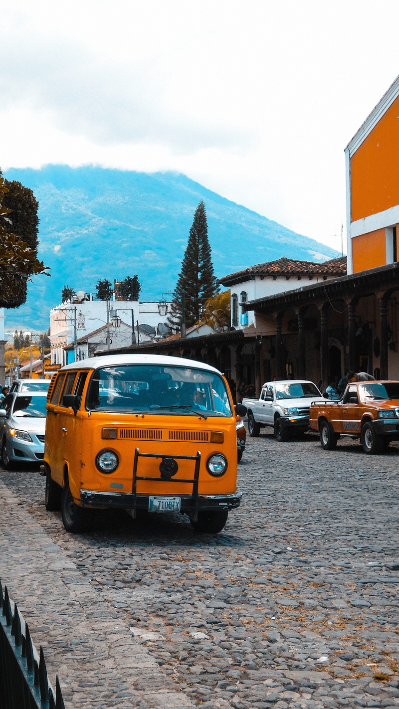 built structure, land vehicle, vw, sky, vehicle, holiday, public transportation, mode of transportation, hippie, outdoors, old, volkswagen, road, beetle