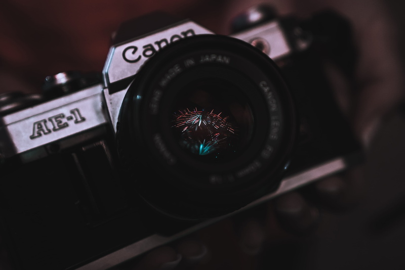 camera - photographic equipment, lens - optical instrument, camera, photography themes, focus on foreground, arts culture and entertainment, dark, text