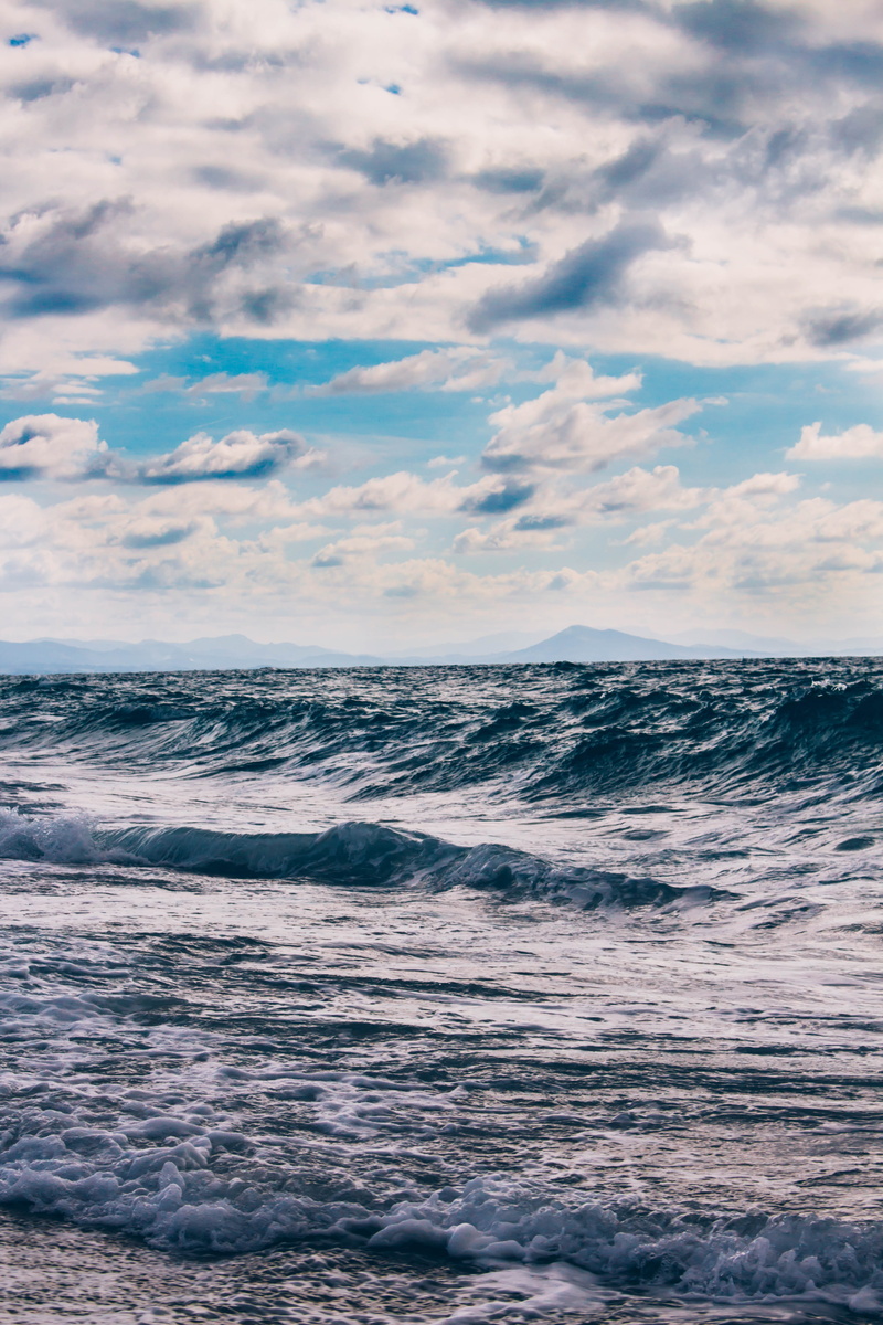 sky, mountain, ocean, sun, waterfront, wave, beach, beauty in nature, sport, flowing water, no people, vibe, horizon over water, motion, outdoors, horizon