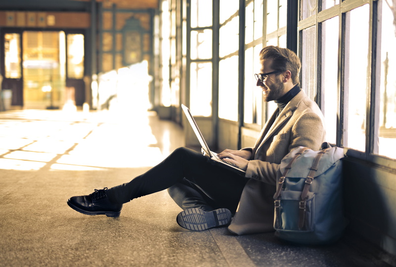 online, sunlight, young adult, 30-35 years old, long overcoat, travel bag, sit, indoor, black sweater, leisure activity, city, man, sack, side view, blazer