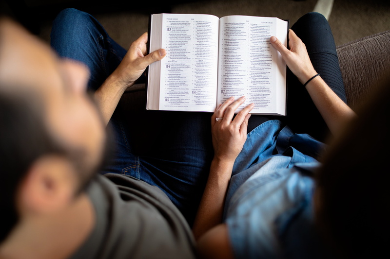education, bible, couch, indoors, psalm, holding, women, husband, couple - relationship, males, over the shoulder view, reading, activity, 5K, marriage