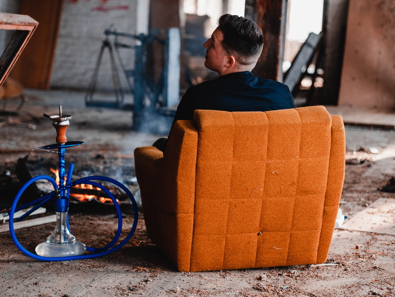 suede, campfire, real people, hookah, box, outdoors, man, men, building, padded, sofa, bike, beside, 4K, person, one person, gray, land vehicle, orange color