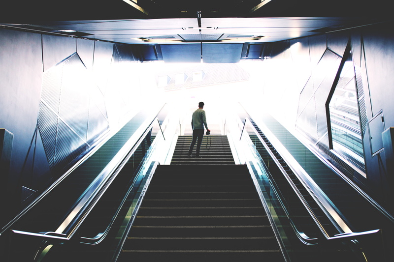 transportation, metal, direction, illuminated, rear view, people Traveling, one person, person, standing, lifestyles, subway, motion, moving walkway, modern