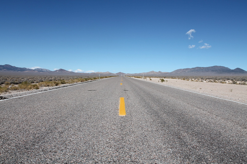 mountain, desert, diminishing perspective, mountain range, sign, marking, direction, asphalt, vanishing point, transportation, landscape, scenics - nature