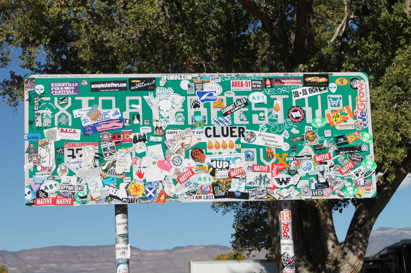 text, multi colored, area 51, sunlight, tourism, communication, no people, road, guidance, travel, nature, architecture, non-western script, sign, plant