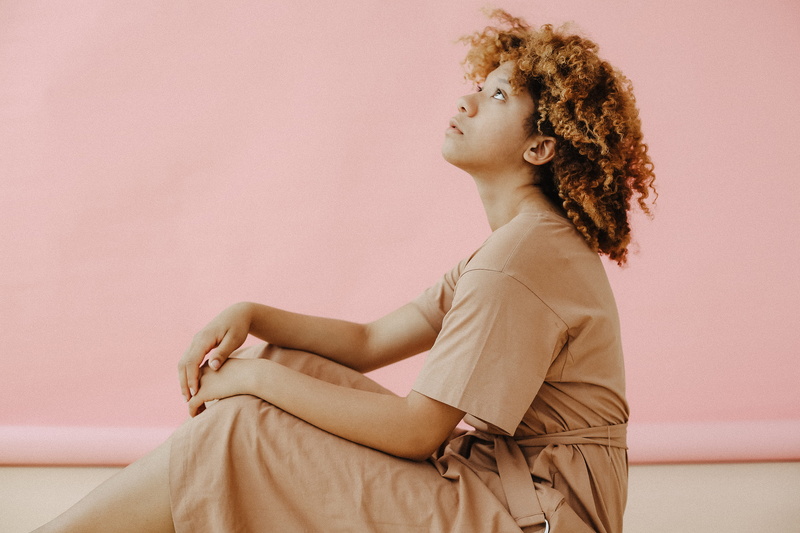 looking away, contemplation, adult, hair, one person, sitting, hairstyle, women, dress, floor, wall - building feature, three quarter length, looking up