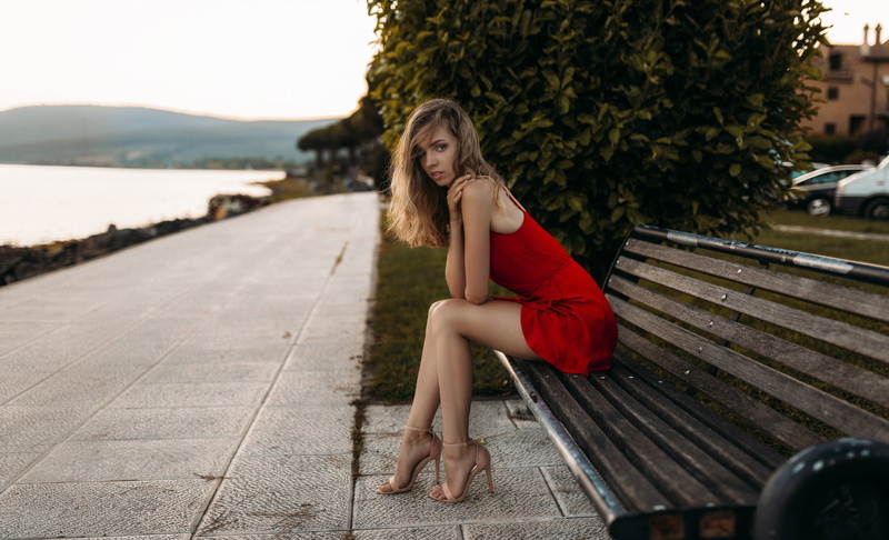 hair, beautiful woman, full length, young adult, looking at camera, fashion, blue eyes, sitting, beauty, bench, outdoors, red dress, hairstyle, long hair