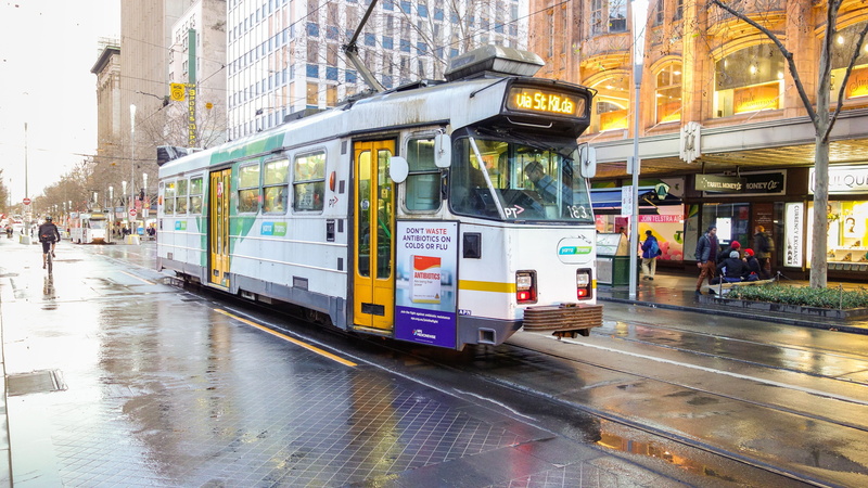 city street, wet, day, building exterior, rail, train, melbourne, traffic, street, rail transportation, tourism, architecture, cable, urban Scene, land vehicle