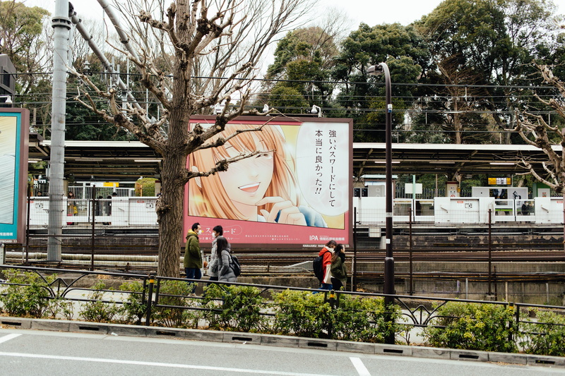 bus stop, four, built structure, walking, real people, plant, reallife, transportation, tree, advertisement, men, railing, people, mode of transportation