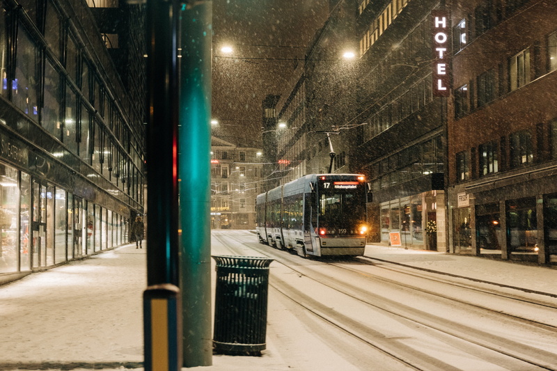 night, person, city, track, built structure, mode of transportation, town, vehicle, train - vehicle, tram, terminal, cold temperature, street, bus, train