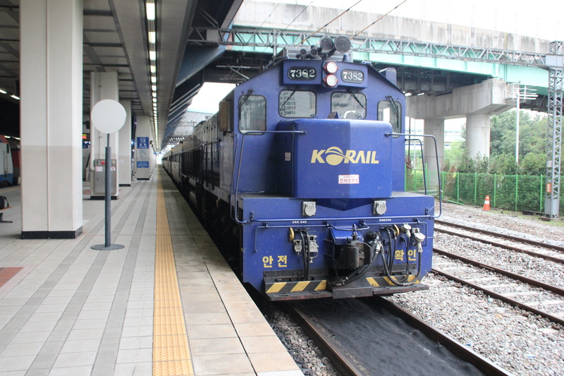 mode of transportation, coach, station, diesel, built structure, bus, railroad car, passenger, architecture, railroad station platform, travel, text, railroad station
