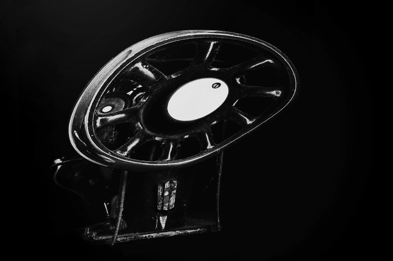 black background, studio shot, technology, vintage, low-light, darkroom, close-up, faded glory, metal, cut out, machine part, shape, old, machine, indoors
